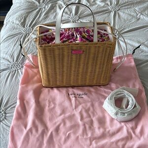 kate spade natural wicker tote with white handles and pink floral liner